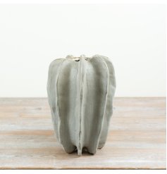 Vase is crafted from natural stoneware and features a sculptural ribbed design.