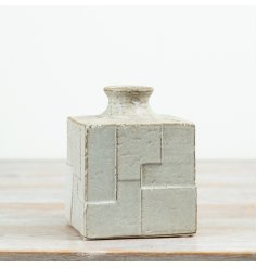 Designed with a clean cube silhouette and raised geometric detailing