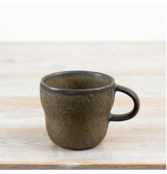 Add natural charm to your daily tableware with this rustic ceramic mug in warm earthy tones.