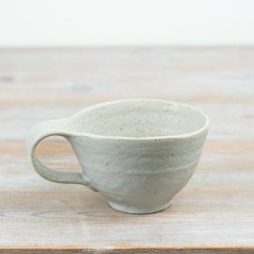 Elevate your tableware with this handcrafted ceramic mug, blending artful design and easy style.
