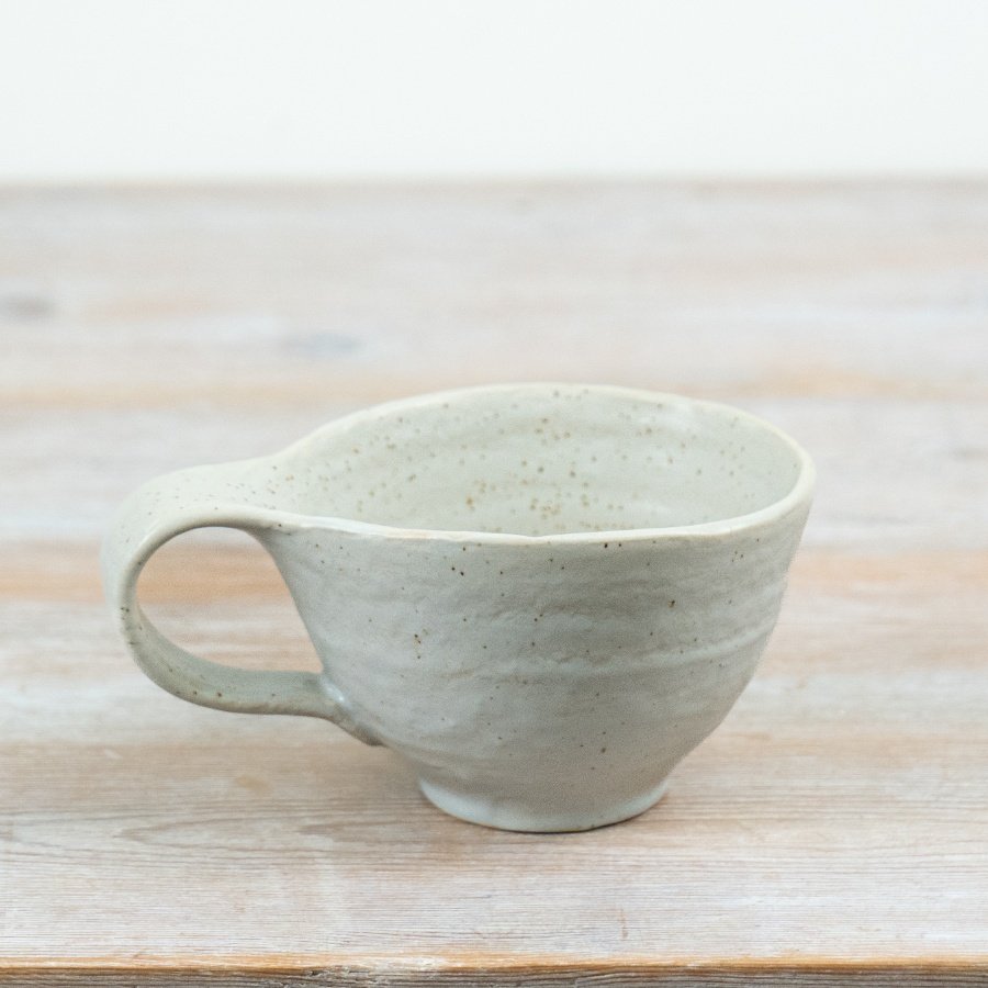 Elevate your tableware with this handcrafted ceramic mug, blending artful design and easy style.