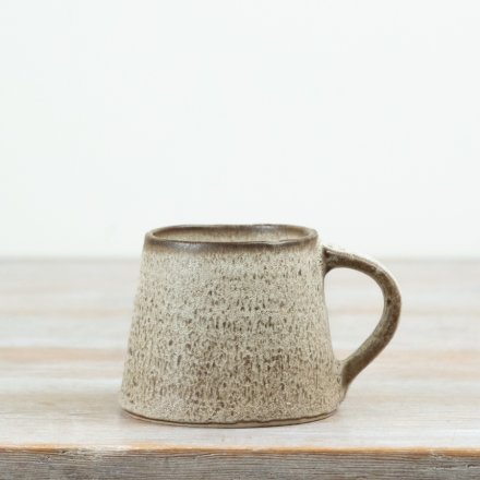 This 12.5cm ceramic mug features a beautifully textured neutral glaze with a soft speckled finish