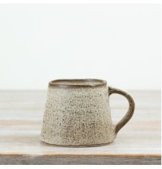 This 12.5cm ceramic mug features a beautifully textured neutral glaze with a soft speckled finish
