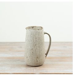 A 21cm decorative jug finished in a warm neutral glaze with subtle speckled detailing for added depth