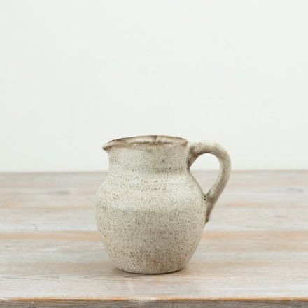 Finished in a warm neutral glaze with delicate speckled detailing