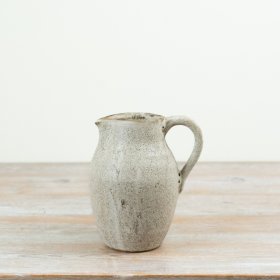 Crafted in a warm earthy tone with subtle speckled detailing,