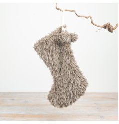 Add cosy texture to festive displays with this soft faux fur Christmas stocking. 