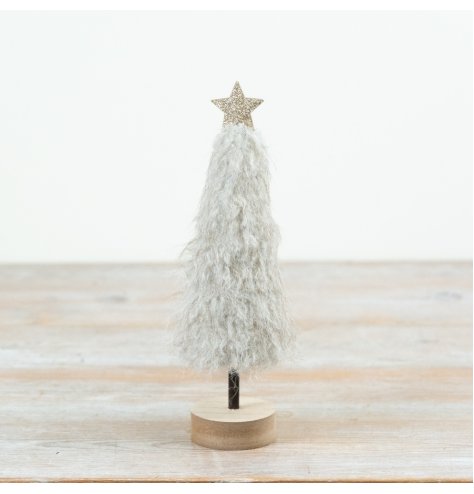 A stylish and softly textured Christmas tree decoration featuring a fluffy neutral finish, wooden base and star topper