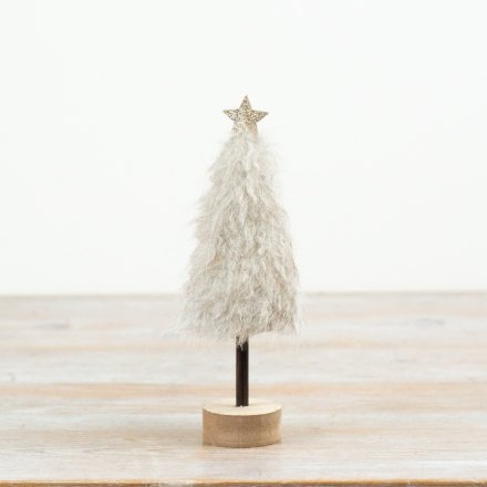 This 20cm tree showcases a fluffy neutral finish with a wooden base and star detail for added charm