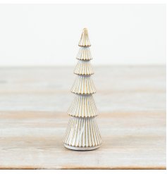 A decorative polyresin tree ornament featuring a whitewash finish with gold trim detailing