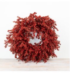 Make a festive impact with this stunning artificial wreath adorned with vibrant red berries.