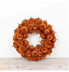 Autumn wreath featuring soft velvet pumpkins in rich, warm burnt-orange shades for a bold seasonal touch.