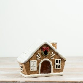 Charming tea light candle holder shaped like a cozy little house.
