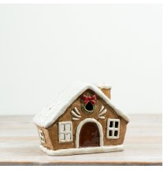 Charming tea light candle holder shaped like a cozy little house.