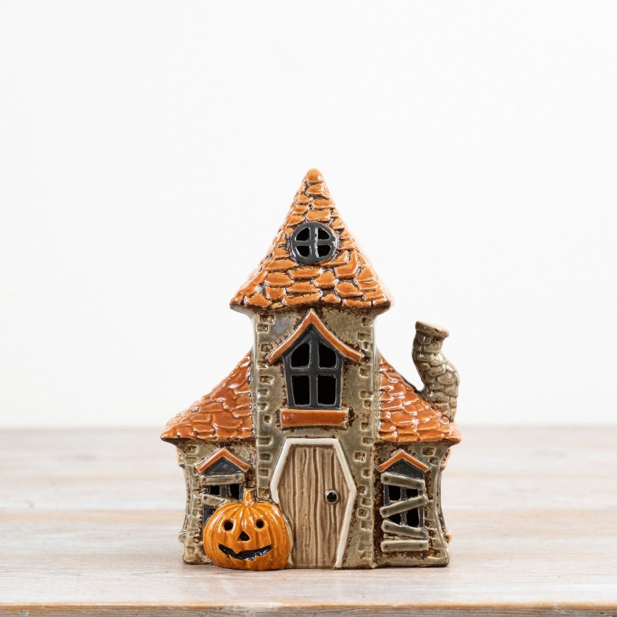 A creepy candle shaped like a haunted house.