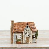 A charming ceramic house tealight holder with beautifully moulded details and a softly distressed finish. 