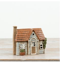 A charming ceramic house tealight holder with beautifully moulded details and a softly distressed finish. 