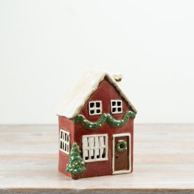 A charming tealight candle house featuring classic red tones with a traditional design.