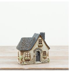 Beautifully crafted in ceramic, this 16cm candle house showcases intricate handpainted details