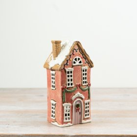Bring warm charm to your space with this stylish brown ceramic tall tealight candle house.
