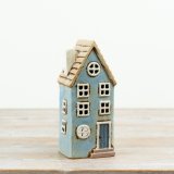 This 22cm ceramic candle house features a soft coastal blue finish with distressed detailing for added character.