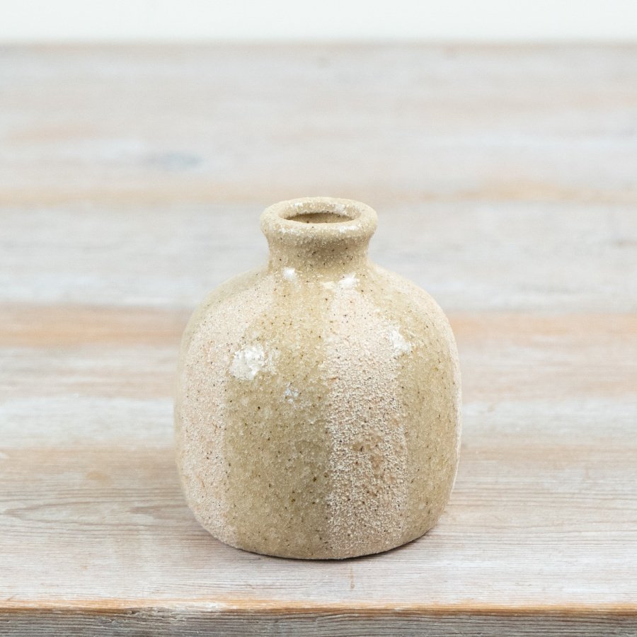Bring natural charm to your decor with this ceramic vase featuring a stripped,