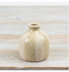 Bring natural charm to your decor with this ceramic striped earthy vase.
