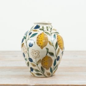 Add cheer to your room with this vibrant yellow ceramic vase shaped like a lemon.