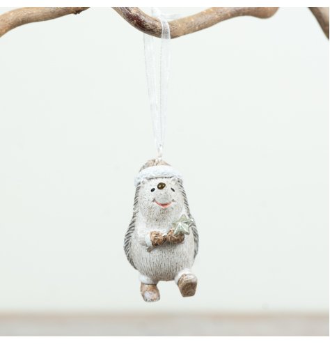 Charming hedgehog ornament with star and ribbon adding festive woodland cheer