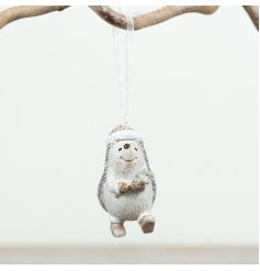 Charming hedgehog ornament with a star and ribbon for a festive woodland touch