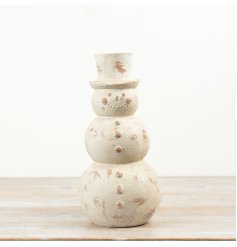 Bring timeless festive charm to your seasonal collection with this distressed cream snowman ornament. 