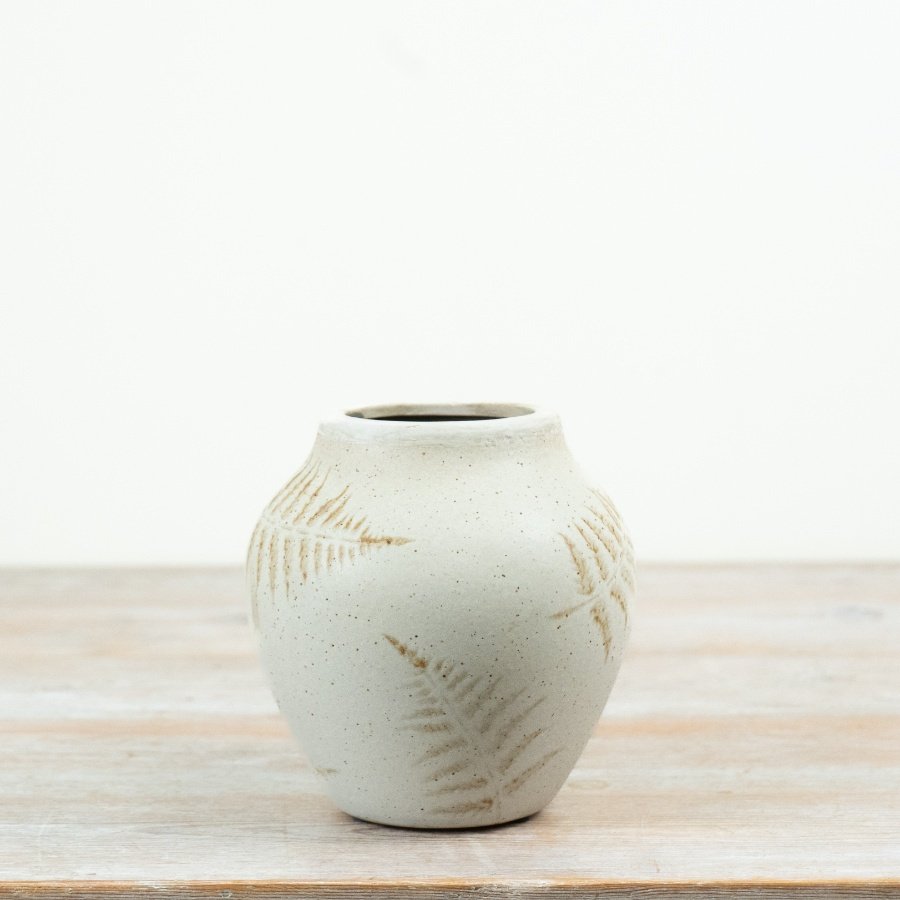 Add understated botanical charm to your range with this elegant ceramic decorative vase.