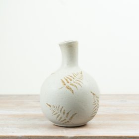Enhance your decor with this stylish vase featuring a unique embossed leaf pattern.