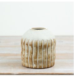 A beautiful 13.5cm ceramic vase in natural tones, complete with engraved vertical stripe detailing. 