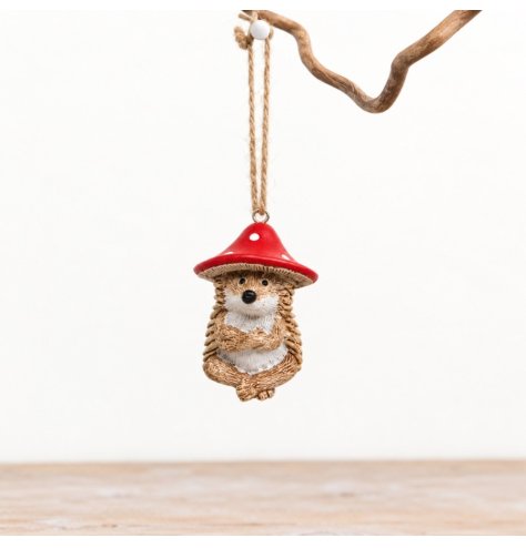 Charming hedgehog ornament topped with a vibrant red mushroom and jute loop