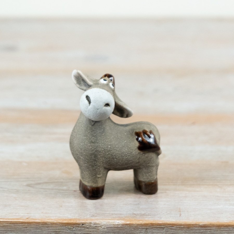 A donkey ornament Finished in a soft, natural taupe glaze with contrasting darker hooves and tail detail