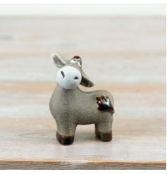 Add a touch of rustic charm to home décor collections with this delightful donkey ornament.