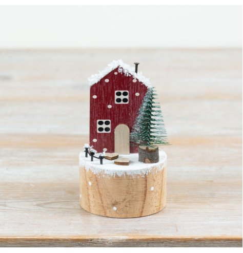 Bring warmth to decor with this charming wooden winter house seasonal decoration.