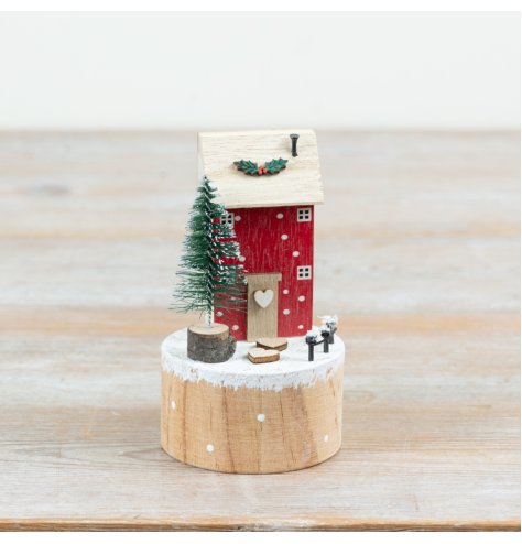 Craft a cosy holiday scene with this charming wooden winter house ornament.