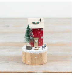 Craft a cosy holiday scene with this charming wooden winter house ornament.