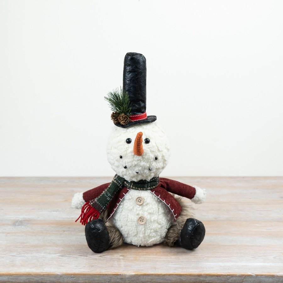 Add a charming seasonal character to festive displays with this delightful sitting snowman decoration.