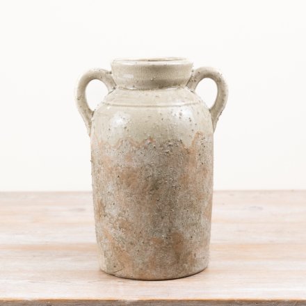 A stylish terracotta urn vase  with a softly aged finish and twin handles for timeless appeal.
