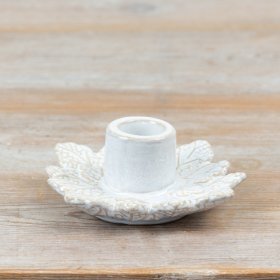 Ceramic candle holder with intricate leaf patterns and a gentle, neutral-toned finish.
