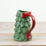 A striking ceramic Christmas tree pitcher with bow handle.