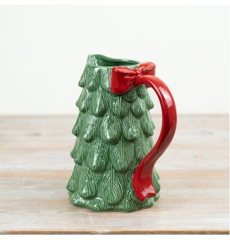 A striking ceramic Christmas tree pitcher with bow handle.