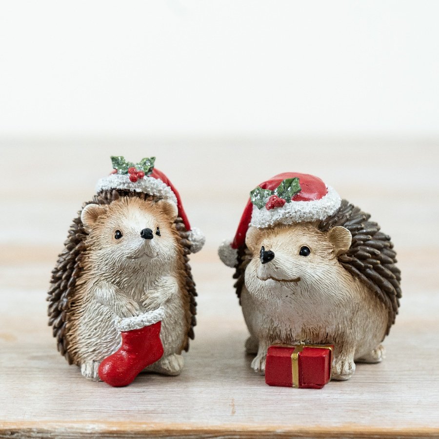 Bring holiday cheer with this cute 2-piece Resin Christmas Hedgehog table decoration.