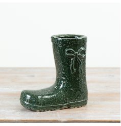 This decorative welly boot vase is finished in a deep green glaze with subtle texture and bow detailing