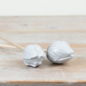 Bring charm to any room with this delicate speckled white tulip on a natural wooden stake.