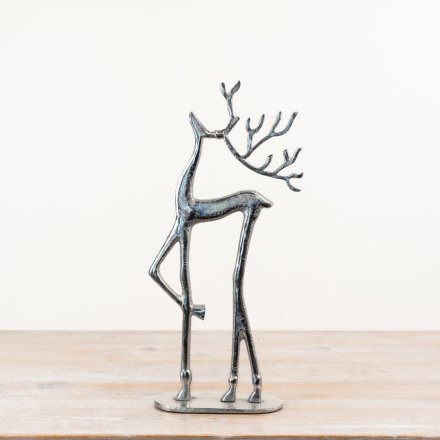 Adorable reindeer figurine standing on a decorative base.