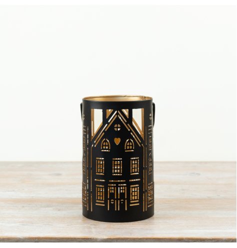 a stylish candle holder with cut house detailing 